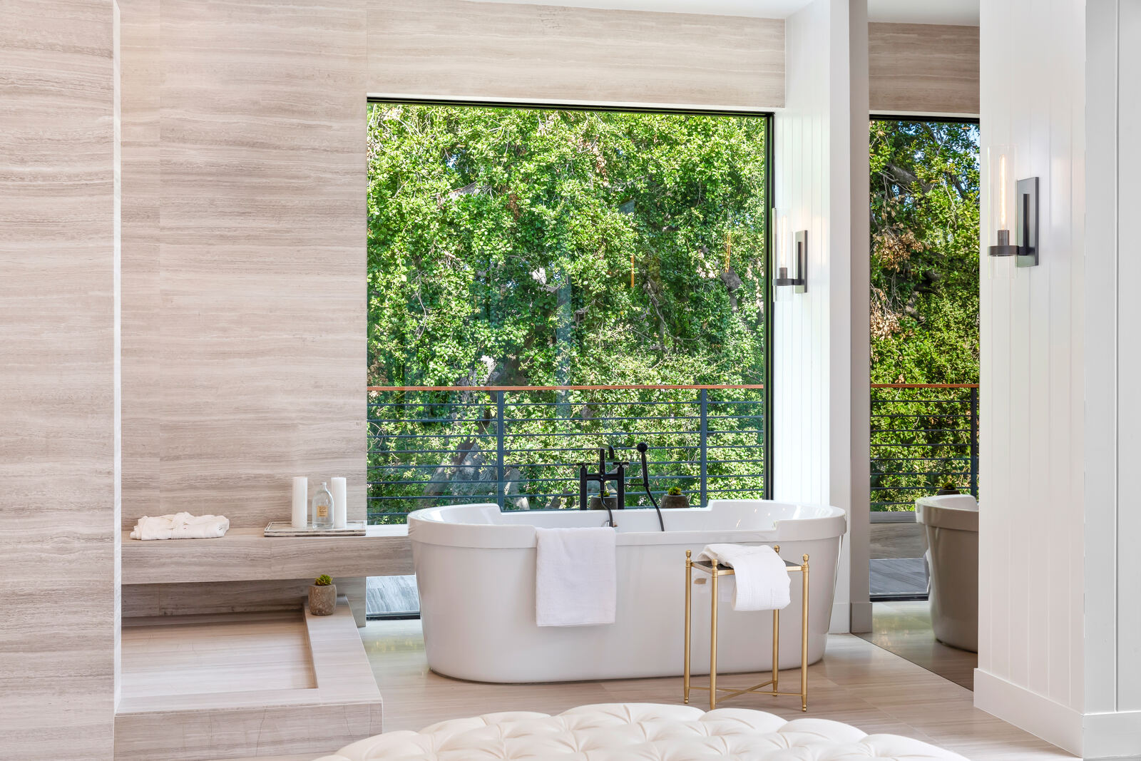Freestanding tub beside large windows and balcony view in Los Angeles