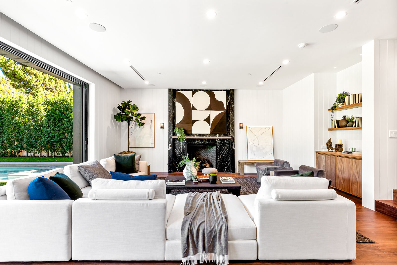 White living room with a black marble fireplace in a Los Angeles remodel