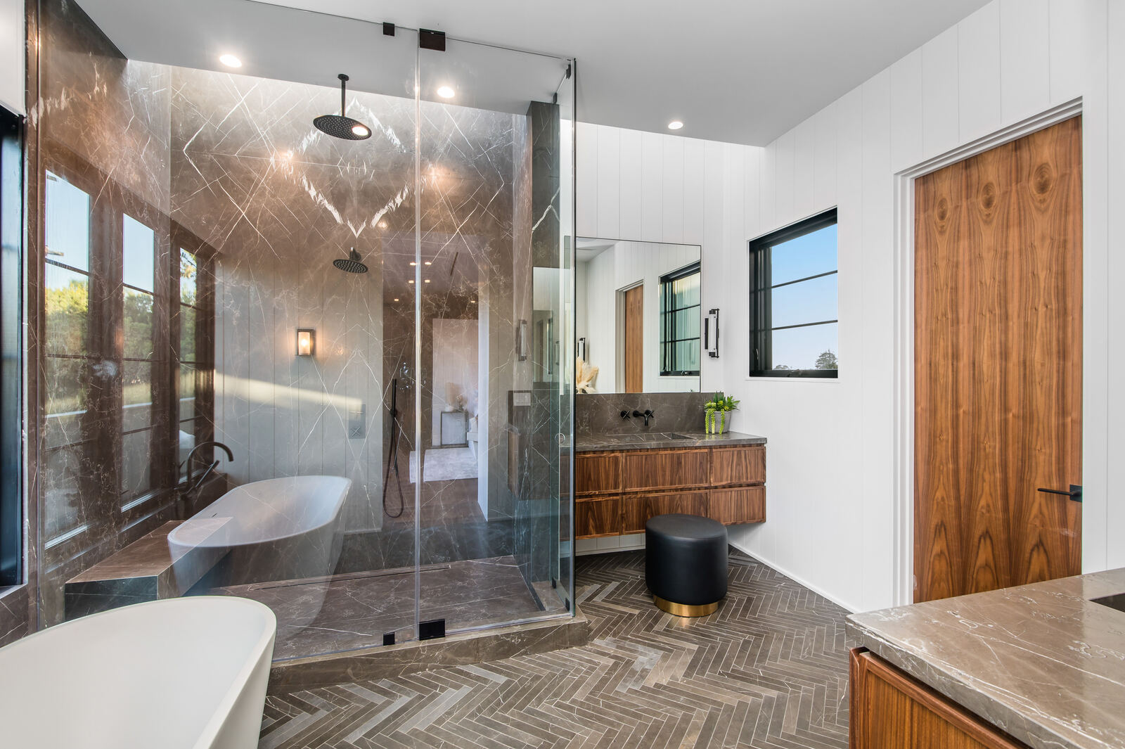 Luxury Los Angeles bathroom with glass shower, tub and wood vanity